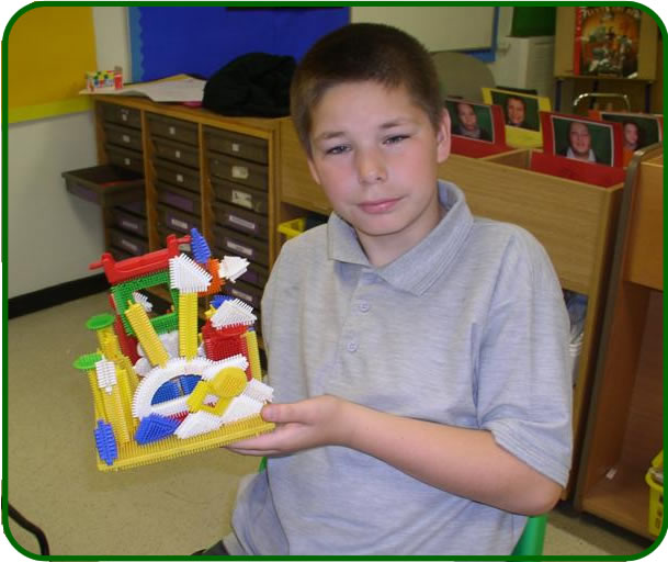 Student proudly displaying a model